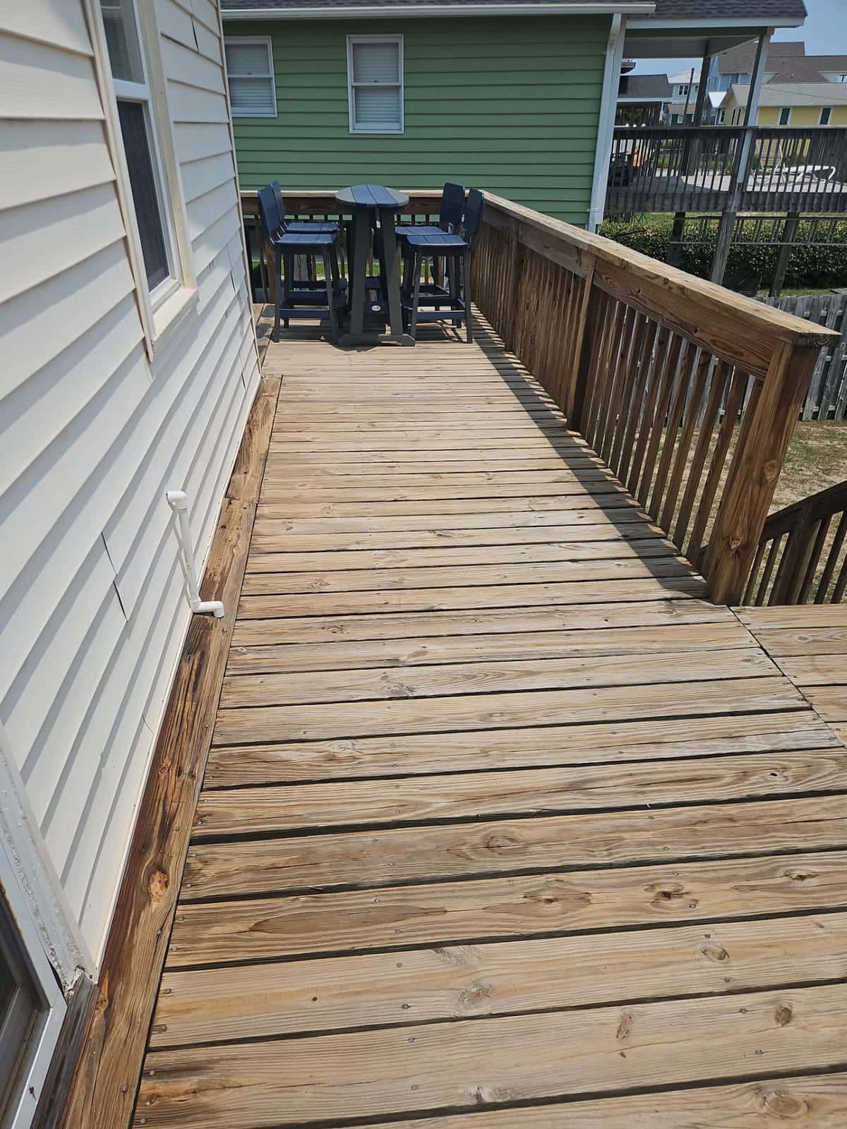 After: Wood deck cleaning before and after in the Wilmington, NC area: gray weathering and buildup removed from deck boards and railings