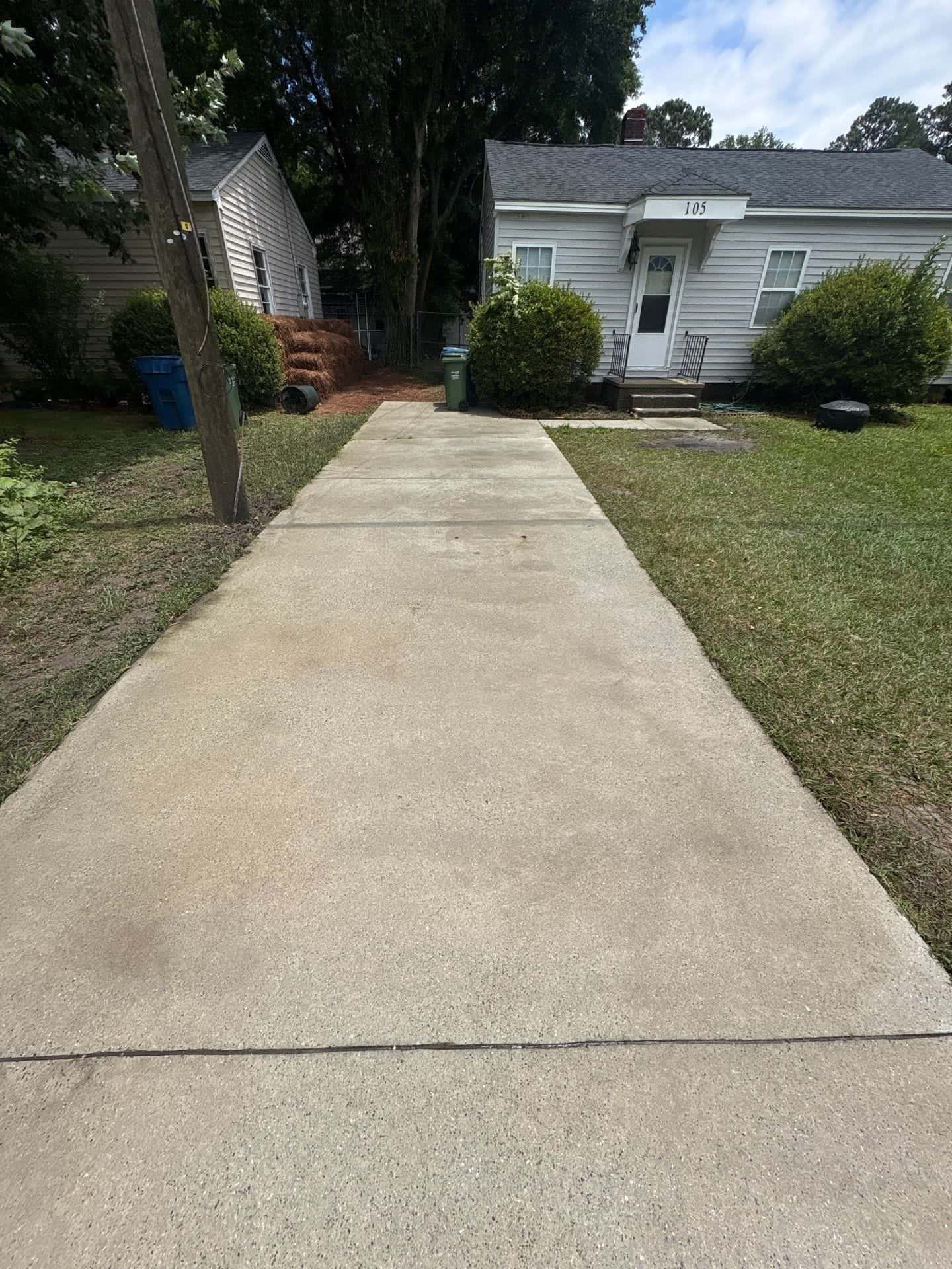 After: Concrete driveway cleaning before and after in the Wilmington, NC area — dark stains and mold lifted from concrete