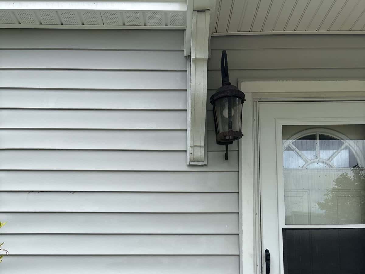 Clean white siding and front entry after a house soft wash in the Wilmington, NC area